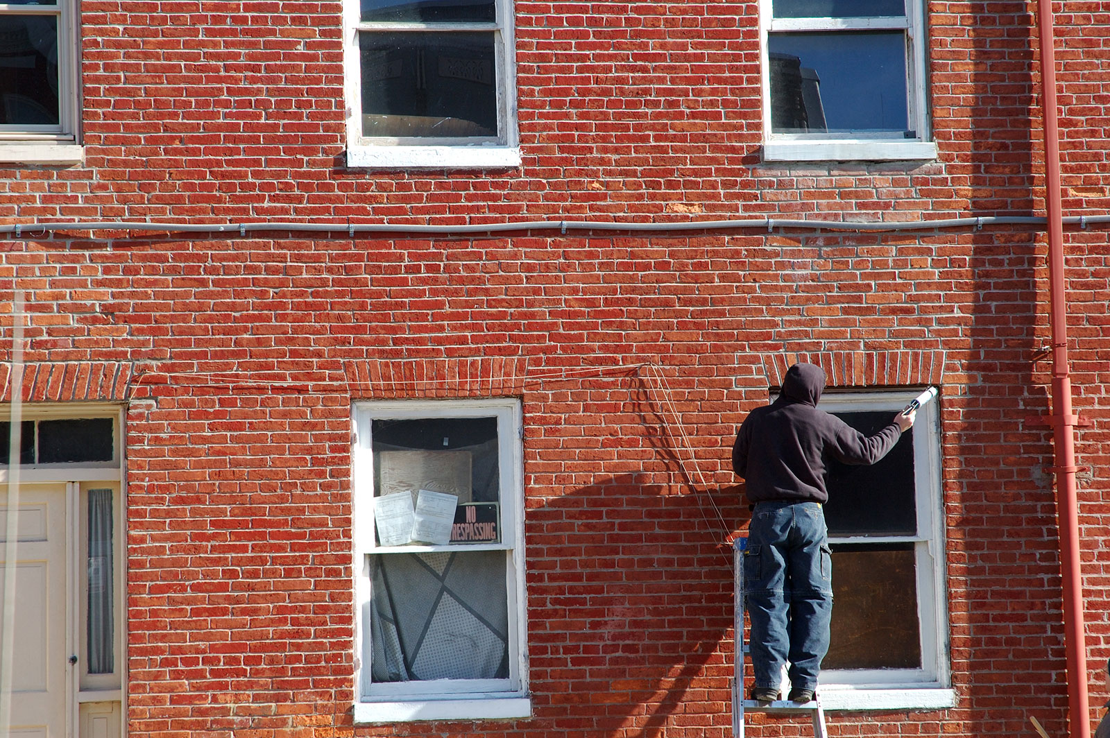 Man painting a window frame